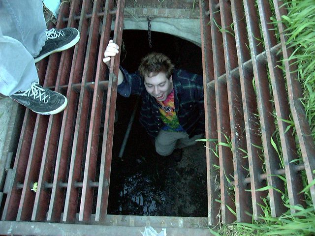 We decide to do some Urban Exploration. Thats Kweejee climbing out of a tunnel.