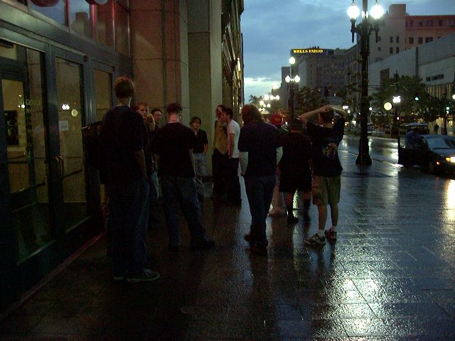 Satnding outside, in the rain.