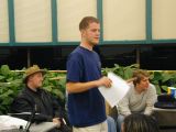 Grifter commands everyone to shut up so he can start his talk.